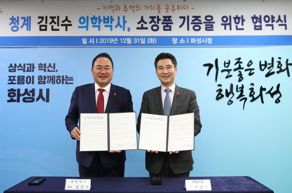 화성시가 시청 상황실에서 청계(靑溪) 김진수 의학박사의 소장품 기증을 위한 업무협약을 기념하고 있다.(사진제공=화성시청)