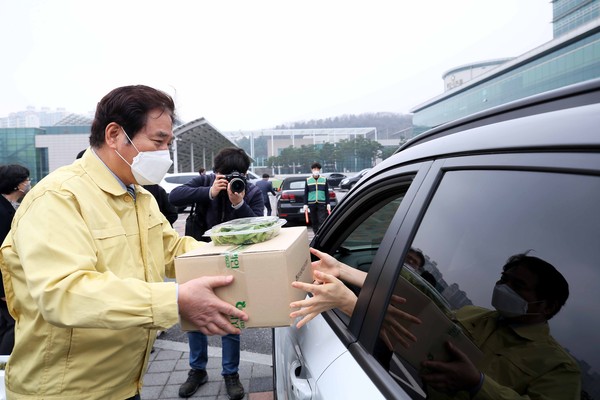 백군기 용인시장이 시청 드라이브 스루 마켓에 직접 참여해 친환경농산물과 화훼 등을 판매했다. (사진제공=용인시청)