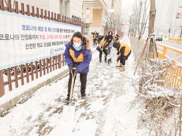 하나님의 교회 신자들이 화성 동탄 신도시에서 학교 앞 인도 제설봉사에 여념이 없다.  (사진제공=하나님의교회)