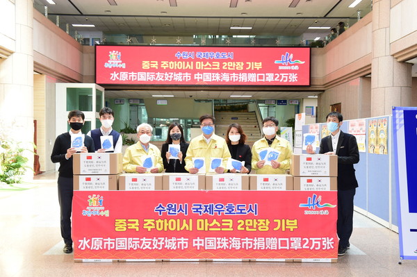 지난 2020년 4월 주하이시가 보낸 마스크 2만장이 수원시장에 도착한 뒤 염태영 수원시장과 수원시 공직자들이 기념촬영을 하고 있다. (사진제공=수원시청)