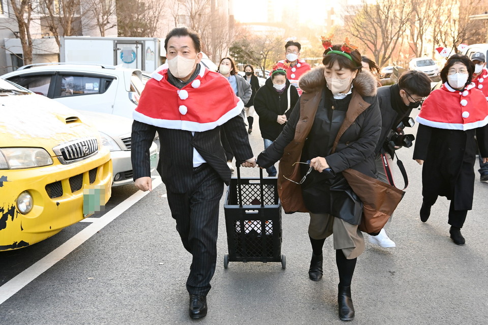 이재준 수원특례시장이 14일 우만종합사회복지관이 주최한 ‘우리동네 주민과 함께하는 김장산타 나눔 대작전’에 참여, 봉사자들과 함께 취약계층 주민에게 배달할 김장을 옮기고 있다. (사진제공=수원특례시청)