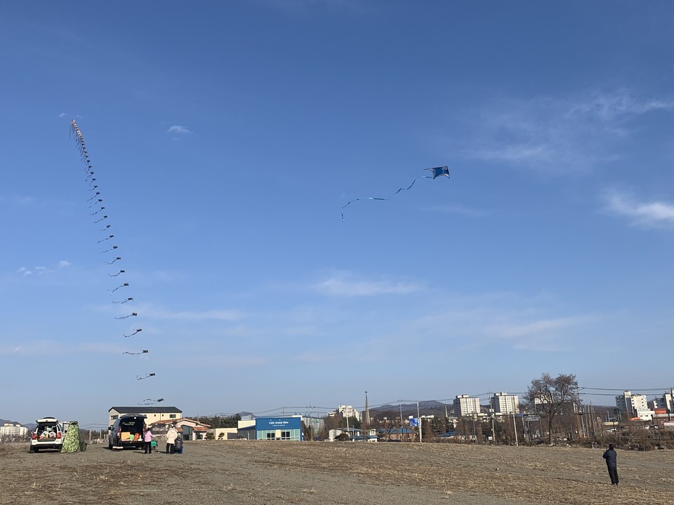■7일 일요일인 오늘 경기·인천지역은 대체로 맑고, 전날부터 곳곳에 내리던 눈이 새벽까지 이어지겠다. 예상 적설량은 인천·경기남부 1~5㎝, 서울·경기북부, 서해5도 1~3㎝ 정도로 예상된다. 아침기온이 크게 떨어져 빙판길과 도로 살얼음에 유의해야 한다. 사진은 전날 오후 3시30분께 연천군 전곡리 선사유적지 앞에서 80세 어르신이 동심에 빠진 듯 150개의 태극기가 달린 '줄 연'을 날리고 있다. (사진=오기춘 기자)