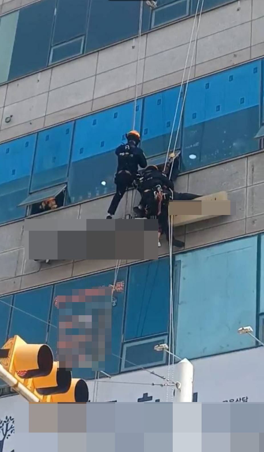 시흥의 한 상가건물 3층 외벽 간판 위에 앉아있던 90대 치매노인이 무사히 구조됐다. 사진은 구조 장면. (사진제공=경기도소방재난본부)