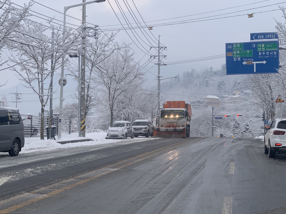 21일 오전 8시17분께 동두천시 탑동동 간선 도로변에 대형 제설 차량이 바삐 움직이며 새벽에 내린 눈들을 치우고 있다. (사진=오기춘 기자)